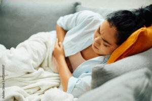 Woman suffering form painful period cramps, Seattle WA